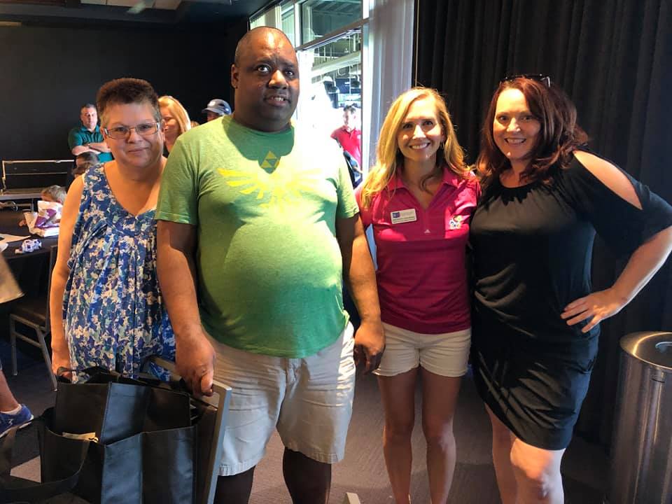 Image is of Audio-Reader listener Duyahn W. along with attendees and A-R staff at the Audio-Reader Topgolf fundraiser on June 13, 2021