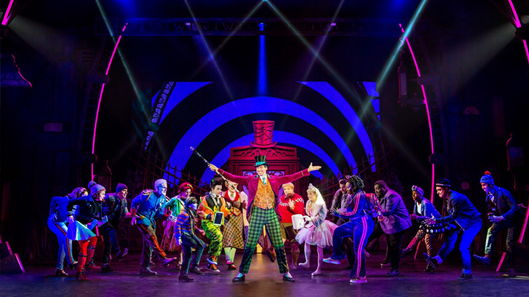 a colorful stage production of Willy Wonka & The Chocolate Factory