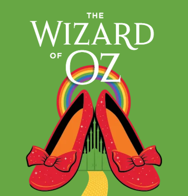 The Wizard of Oz in large white text above a pair of shimmering ruby slippers surrounded by a rainbow with a yellow brick road at the bottom of the image.