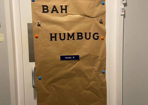 Door number 12 is covered in brown paper with the words "Bah Humbug" at the top of the door. 