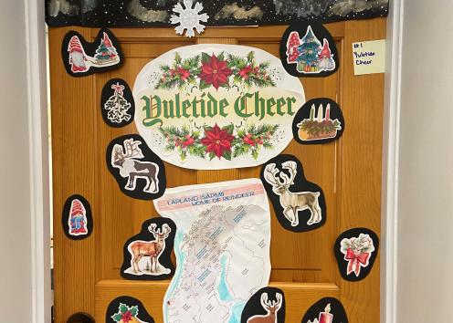 Door number one, featuring some reindeer, a map of Scandinavia, northern lights, and the words Yuletide Cheer. 
