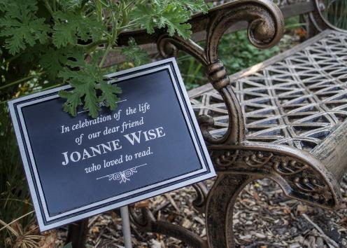 the plaque says "in celebration of the life of our dear friend Joanne Wise who loved to read"
